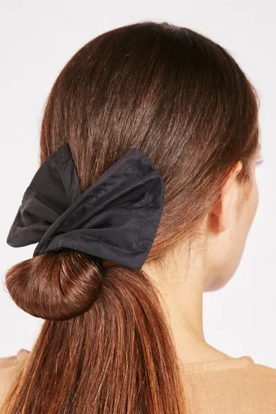 Model wearing WOW Hair Twisty hair bow accessory in ponytail